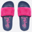 A pair of slide sandals with navy blue footbeds, bright pink faux-fur straps, and pink script branding on the footbeds