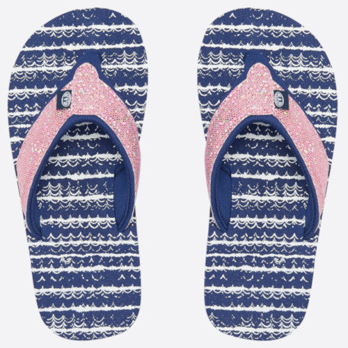 A pair of flip-flops with navy blue and white wavy patterned soles and glittery pink straps Main image